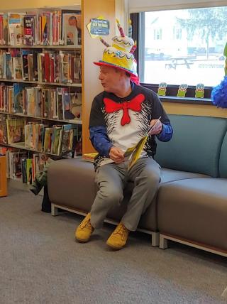 Picture of Mayor Medany from March 2020 reading in a cat in the hat costume